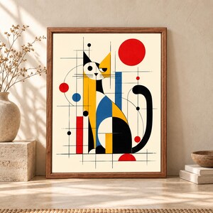 Framed geometric cat wall art with a stylized black, yellow and blue cat surrounded by red circles, abstract lines and Bauhaus-inspired shapes on a warm cream background.