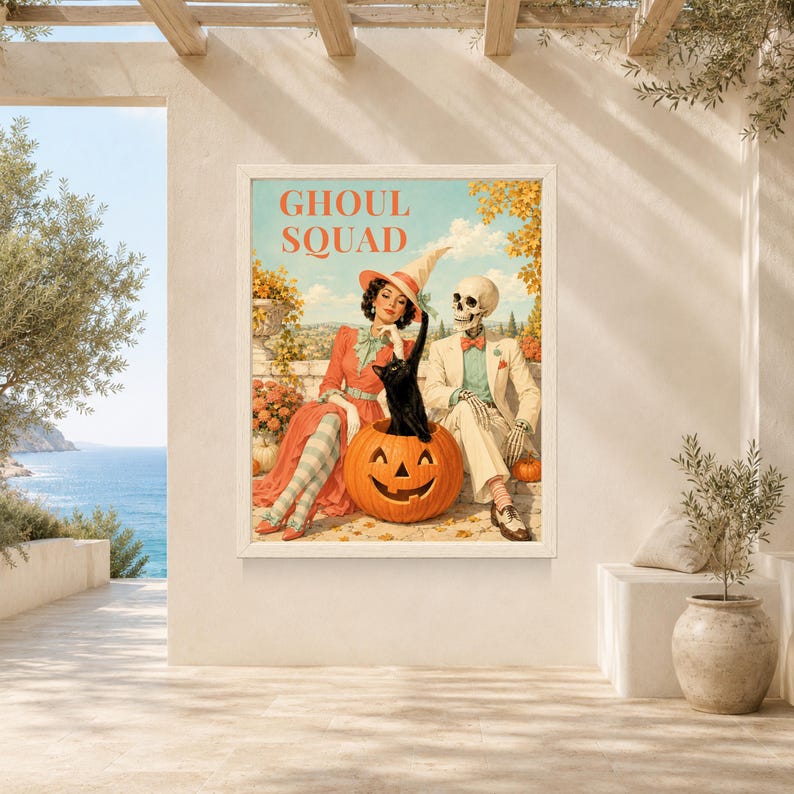 May include: A rectangular wall art print featuring the text GHOUL SQUAD at the top. The illustration depicts a person in a red dress and witch hat sitting next to a skeleton in a suit, with a black cat emerging from a large carved pumpkin.