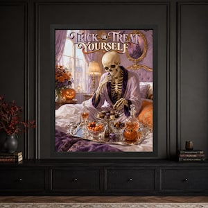 Framed funny Halloween wall art showing a skeleton in a purple robe sitting on an ornate bed with chocolates, candy corn, a silver tray and jack-o’-lantern beneath Trick or Treat Yourself lettering.