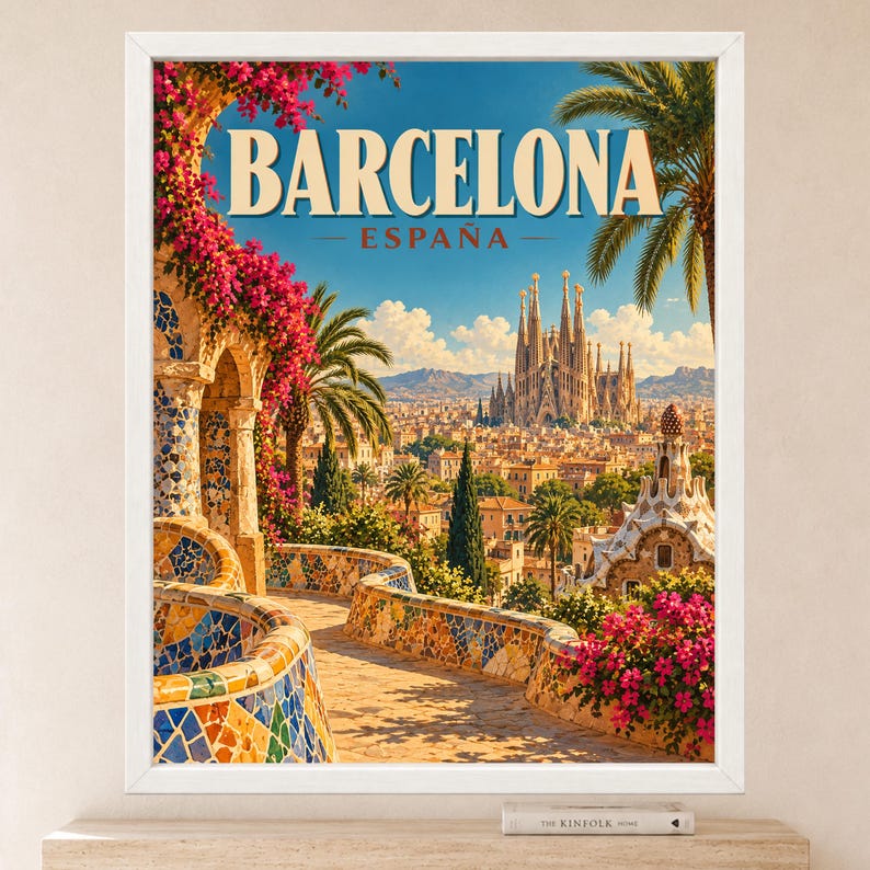 May include: A framed travel poster featuring a vibrant view of Barcelona, Spain. The image displays the Sagrada Familia in the distance, framed by colorful mosaic stone walls, bright pink bougainvillea flowers, and green palm trees under a blue sky.