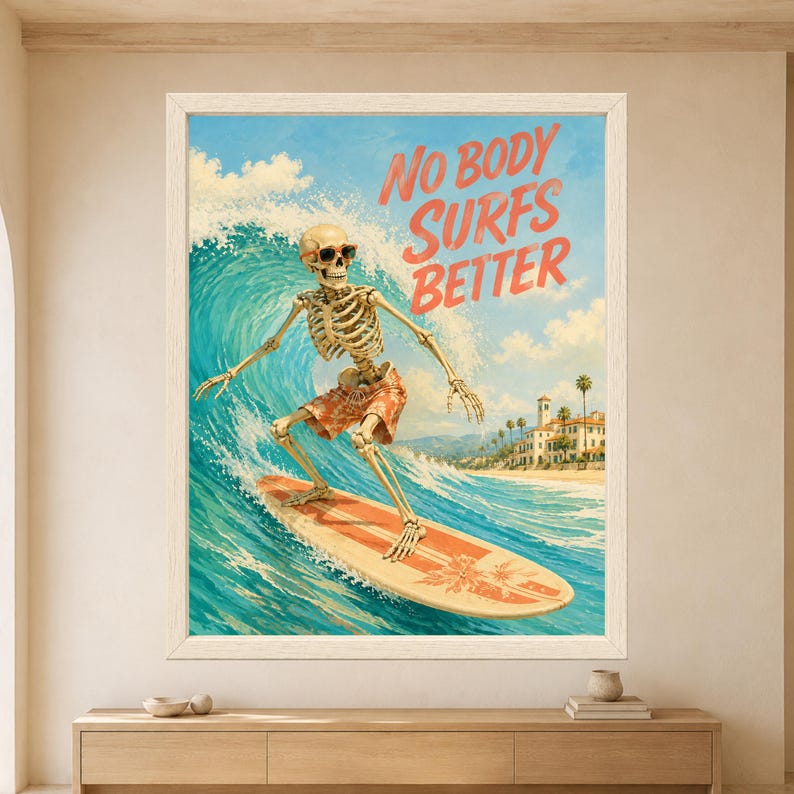Framed No Body Surfs Better skeleton wall art featuring a sunglasses-wearing skeleton surfing a turquoise wave on a coral retro surfboard with sunny coastal town and blue summer sky.