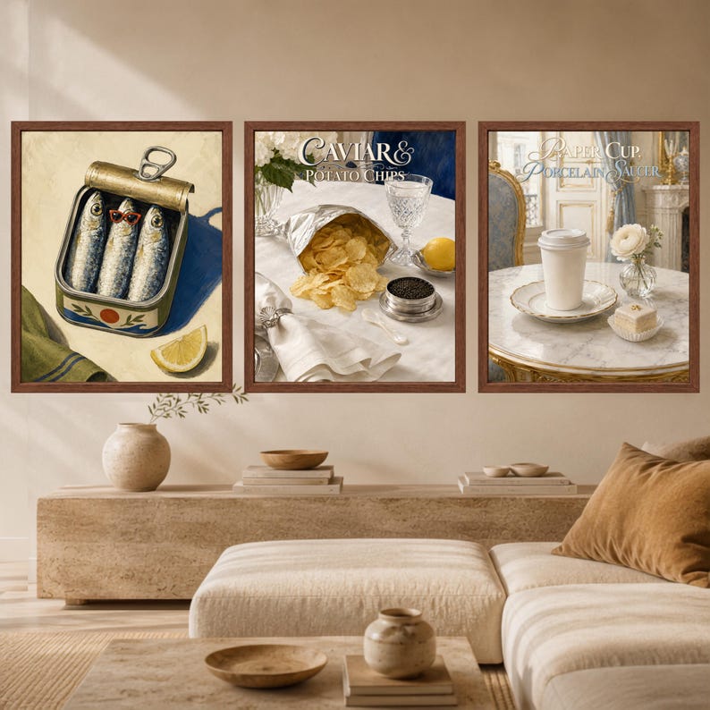 May include: A set of three framed wall art prints. The first shows sardines in a tin with a lemon slice. The second displays a bag of potato chips, caviar, and a glass with the text Caviar & Potato Chips. The third depicts a paper cup on a saucer.