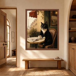 May include: A framed wall art print depicting a black and white cat sitting on a chair at a small round table with a cup of coffee and a newspaper, set against a Parisian street scene featuring the Eiffel Tower under a red awning.