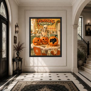 May include: A framed wall art print titled PUMPKIN PROBLEMS featuring a skeleton wearing an apron carving three orange pumpkins on a kitchen table. One pumpkin has a black cat peeking out from inside, while the others have carved faces.