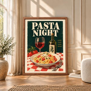 Framed Pasta Night kitchen wall art featuring spaghetti with tomatoes, red wine and olive oil on a red checkered table beneath bold cream lettering on dark green.