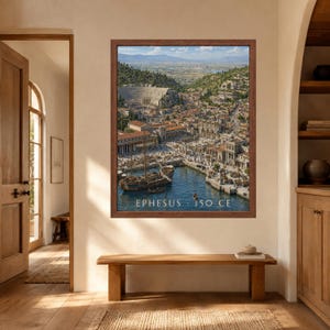 May include: A framed wall art print depicting the ancient city of Ephesus in 150 CE, featuring a harbor with wooden ships, stone buildings, a large theater, and surrounding hills. The text EPHESUS 150 CE is printed in white at the bottom of the image.