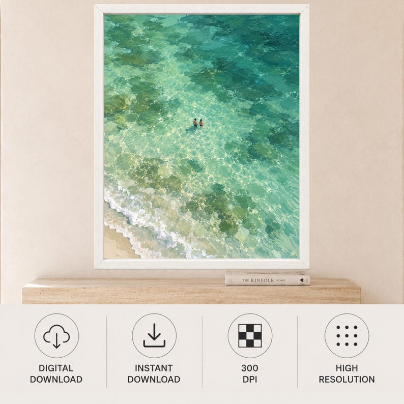 May include: A framed wall art print featuring an aerial view of clear turquoise ocean water with a sandy shoreline and two small figures swimming in the center. The water displays varying shades of green and blue with visible sea floor textures.