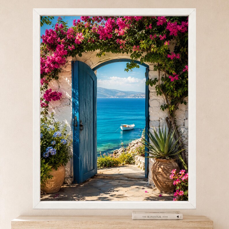 May include: A framed wall art print depicting an open blue wooden door set in a white stone archway covered in vibrant pink bougainvillea flowers. Through the doorway, a calm blue sea with a small white boat is visible under a clear sky.