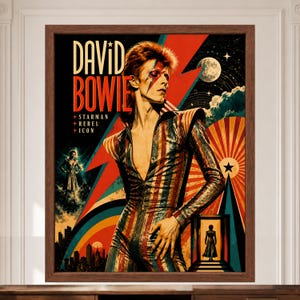 May include: A framed poster featuring a portrait of David Bowie in a striped jumpsuit with a lightning bolt on the face. The text reads DAVID BOWIE, STARMAN, REBEL, ICON. The background includes a red lightning bolt, a moon, and a city skyline.