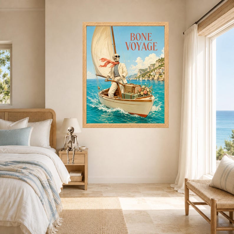 May include: A framed wall art print featuring a skeleton wearing sunglasses, a striped shirt, and a light-colored suit, sailing a small boat on blue water. The text BONE VOYAGE is printed at the top. The scene includes luggage and flowers.