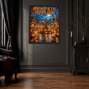 May include: A framed wall art print titled PUMPKIN HOLLOW featuring a night scene of a town square filled with glowing jack-o'-lanterns, a central statue holding a lantern, and illuminated buildings under a full moon in a dark blue sky.