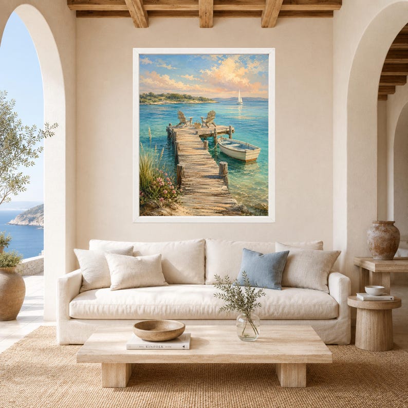 May include: A framed landscape painting depicting a wooden pier extending into calm turquoise water. Two chairs sit on the dock next to a small white rowboat. In the distance, a sailboat floats on the horizon under a soft, golden sunset sky.