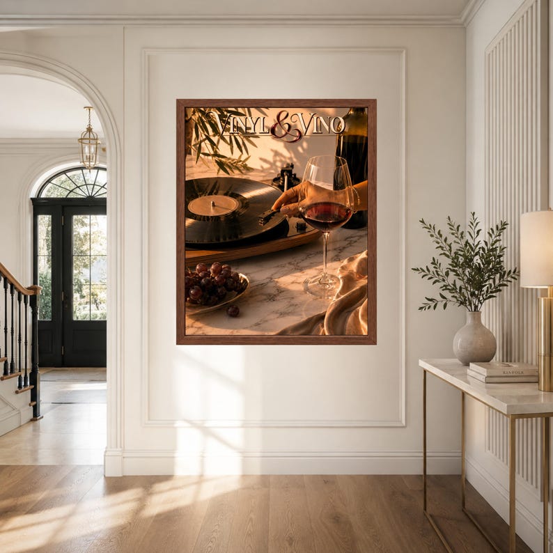May include: A framed wall art print titled Vinyl & Vino featuring a black vinyl record on a turntable, a glass of red wine, and a small bowl of dark grapes on a marble surface, illuminated by warm sunlight casting long shadows across the scene.