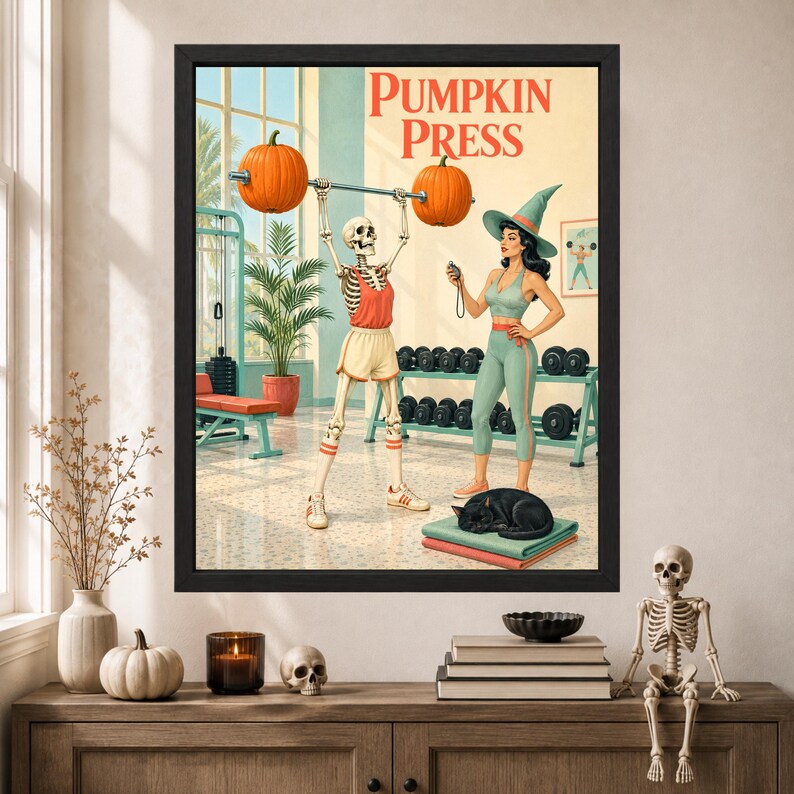 May include: A framed wall art print titled PUMPKIN PRESS featuring a skeleton lifting a barbell with pumpkins as weights, alongside a person in a witch hat holding a stopwatch in a gym. A black cat rests on a stack of mats on the floor.