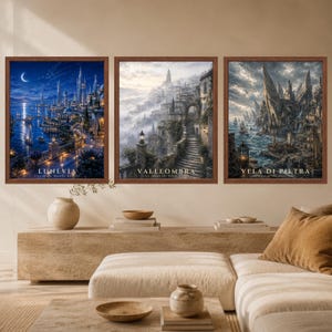 May include: Three framed wall art prints featuring fantasy cityscapes. The left print shows a night scene titled LUNEVIA, the center print shows a misty mountain town titled VALLEOMBRA, and the right print shows a rocky coastal city titled VELA DI PIETRA.