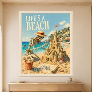 Framed Life’s a Beach skeleton wall art featuring a sunglasses-wearing skeleton building an elaborate sandcastle on a sunny beach beside turquoise sea, coastal villas and striped umbrellas.