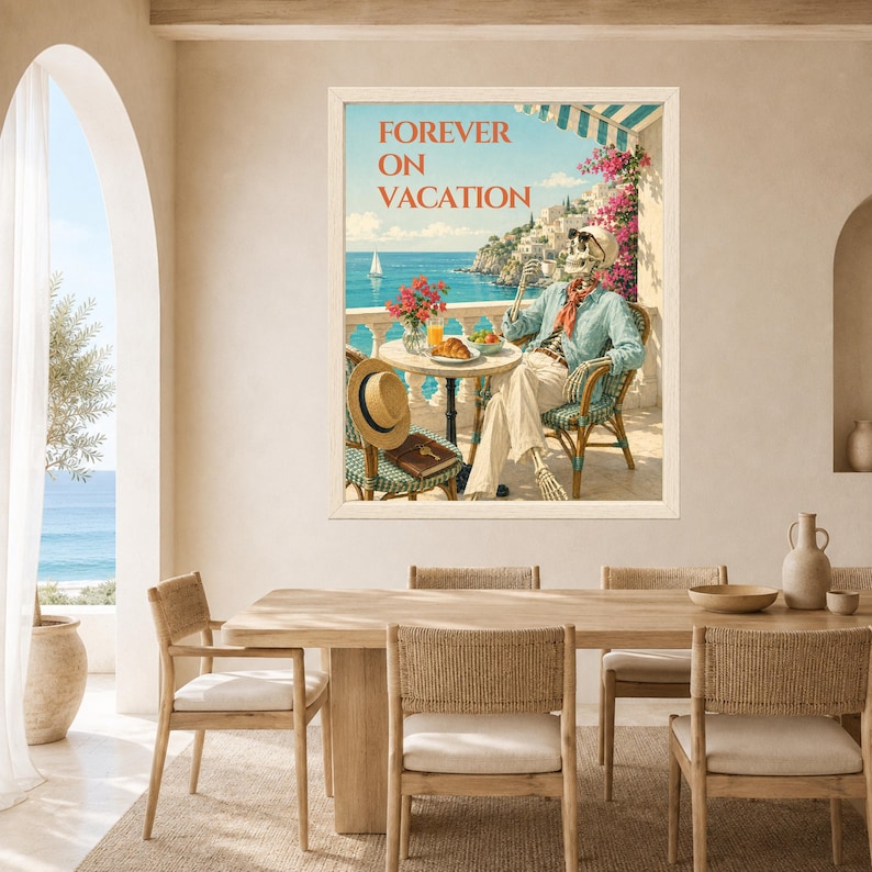 May include: A framed wall art print titled FOREVER ON VACATION featuring a skeleton sitting at a round table on a balcony overlooking the sea. The skeleton wears a light blue shirt and white trousers, holding a cup with a croissant on the table.