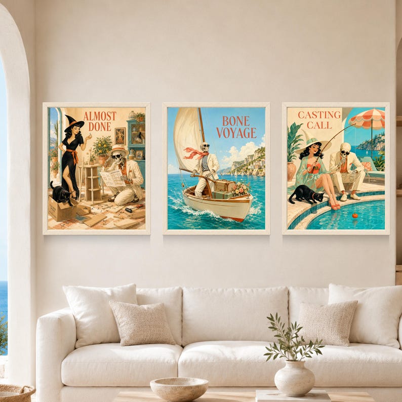 May include: A set of three framed wall art prints featuring vintage-style illustrations. The first shows a witch and a skeleton with the text ALMOST DONE. The second depicts a skeleton sailing a boat labeled BONE VOYAGE. The third shows a person and a skeleton fishing by a pool with the text CASTING CALL.