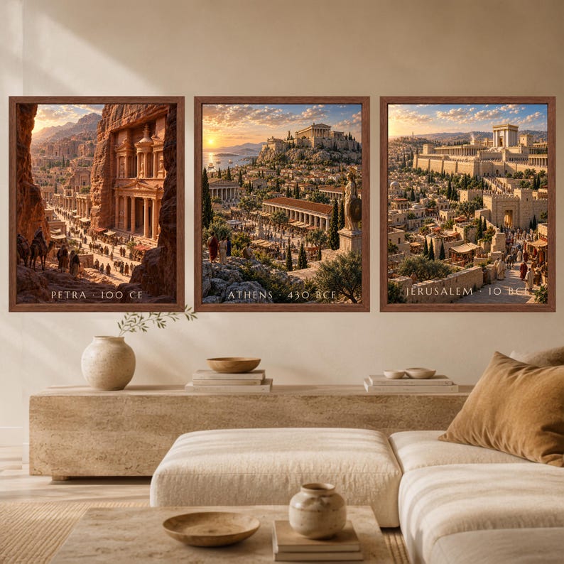 May include: Three framed wall art prints depicting historical cityscapes. The left print shows Petra 100 CE, the center print shows Athens 430 BCE, and the right print shows Jerusalem 10 BCE. Each rectangular print features a brown wooden frame.