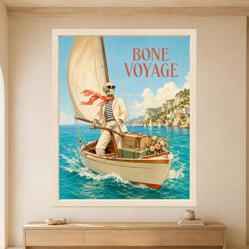 Framed Bone Voyage skeleton wall art featuring a sunglasses-wearing skeleton sailing a vintage boat across turquoise Mediterranean water with white sail, luggage, flowers and sunny coastal cliffs.