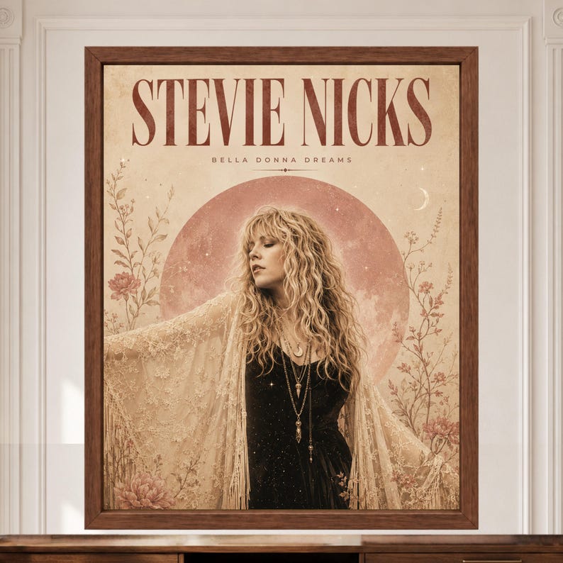May include: A framed wall art print featuring a portrait of Stevie Nicks with the text STEVIE NICKS and BELLA DONNA DREAMS. The image displays a person with long blonde hair, a black top, and a lace shawl against a large pink moon and floral motifs.