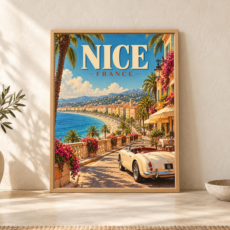 Framed Nice France travel poster showing the French Riviera coastline with blue Mediterranean water, palm trees, pink bougainvillea, café terraces and a cream convertible overlooking the seafront.