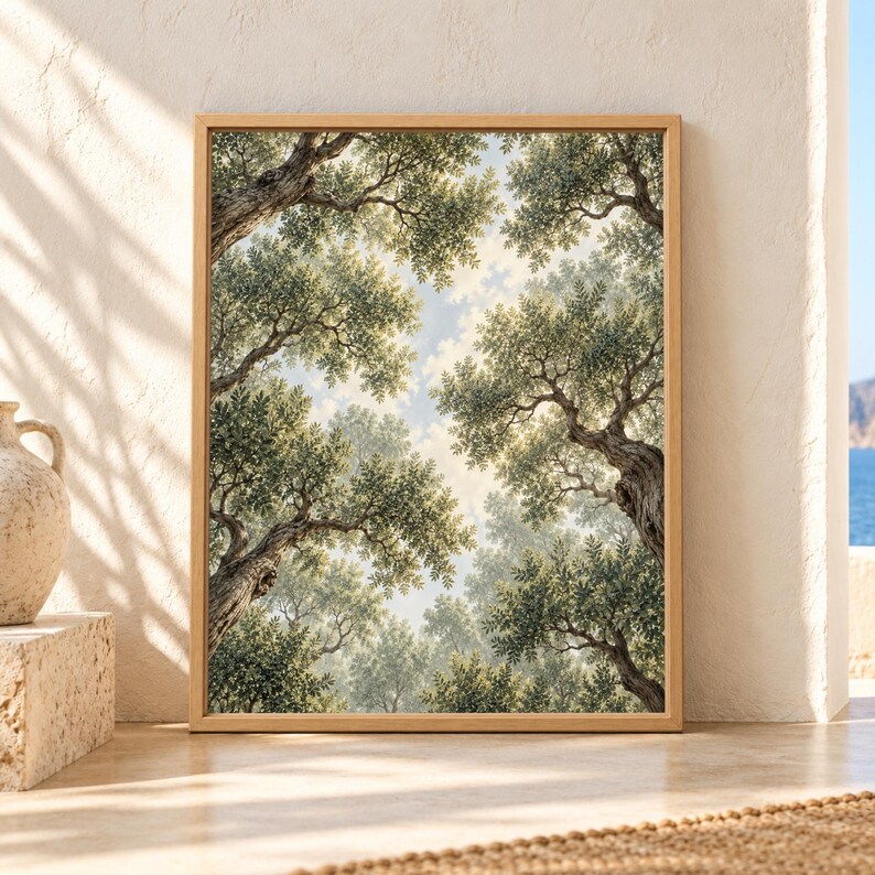 Framed olive tree wall art showing an upward view through mature twisting olive trunks and layered sage green branches surrounding a softly lit patch of sky.