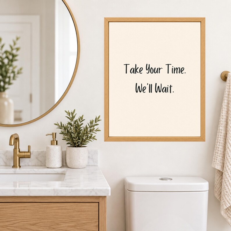 May include: A rectangular wall art piece in a light wood frame featuring a cream-colored background with the black text "Take Your Time. We'll Wait." The print is displayed on a wall, showcasing a simple design with clear, dark lettering.