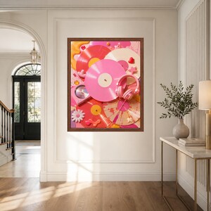 May include: A framed wall art print featuring a vibrant collage of pink, red, and cream vinyl records, a pair of pink headphones, and small decorative elements like a white flower, stars, and hearts against a bright pink background.