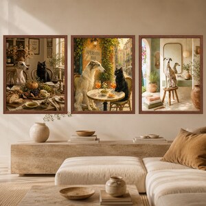 May include: A set of three framed wall art prints featuring illustrations of dogs and cats in various settings. The left print shows a dog and cat at a dining table, the center shows them at an outdoor cafe, and the right shows a dog in a bathroom.