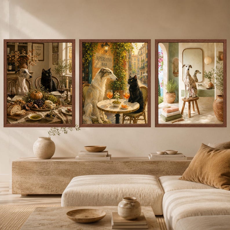 May include: A set of three framed wall art prints featuring illustrations of dogs and cats in various settings. The left print shows a dog and cat at a dining table, the center shows them at an outdoor cafe, and the right shows a dog in a bathroom.