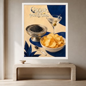May include: A framed art print titled Caviar & Potato Chips featuring a silver bowl of black caviar, a white bowl of golden potato chips, a martini glass with an olive, and a small silver spoon, all set against a cream and blue background.