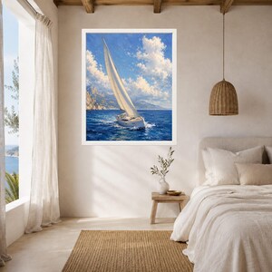 May include: A framed wall art print depicting a white sailboat navigating deep blue ocean waters under a bright sky with fluffy white clouds. The scene features distant rocky cliffs and a clear horizon, captured in a painterly style with visible brushstrokes.