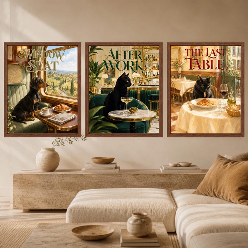 May include: Three framed wall art prints featuring animal scenes. The first shows a dachshund in a train window with the text WINDOW SEAT. The second shows a black cat in a bar with the text AFTER WORK. The third shows a black cat eating pasta with the text THE LAST TABLE.