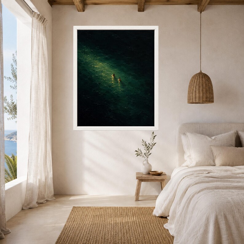 May include: A framed wall art print featuring an aerial view of two figures swimming in deep, dark green ocean water, illuminated by a single, bright shaft of sunlight that highlights the ripples and texture of the sea surface.