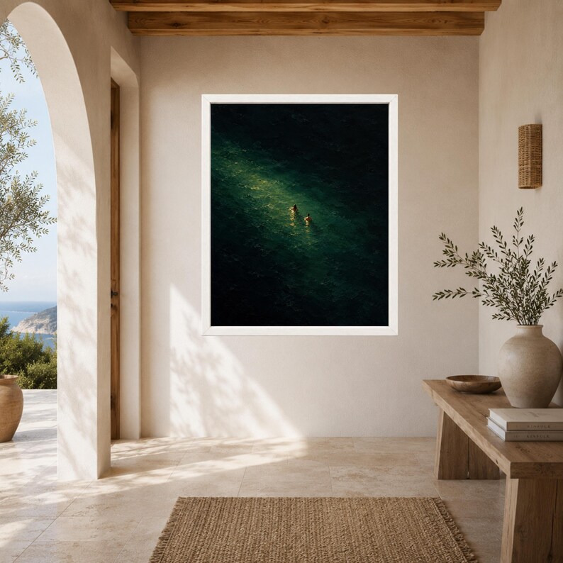 May include: A framed wall art print featuring an aerial view of two individuals swimming in deep, dark green water. A bright, diagonal shaft of sunlight illuminates the water's surface around the swimmers, creating a high-contrast scene.