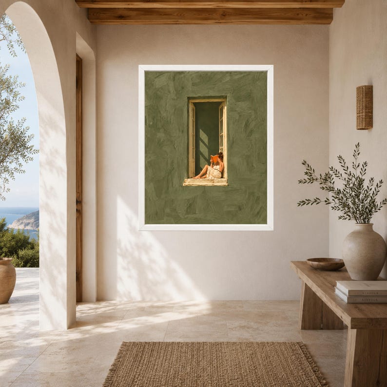May include: A framed wall art print featuring a textured olive green wall with a central rectangular window. Inside the window frame, a person sits while reading an orange book. The artwork is displayed in a white frame on a neutral wall.