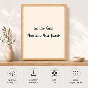 May include: A framed wall art print featuring the black text You Look Good Now Wash Your Hands on a cream background. The frame is made of light-colored wood. Below the frame are four circular icons labeled Digital Download, Instant Download, 300 DPI, and High Resolution.