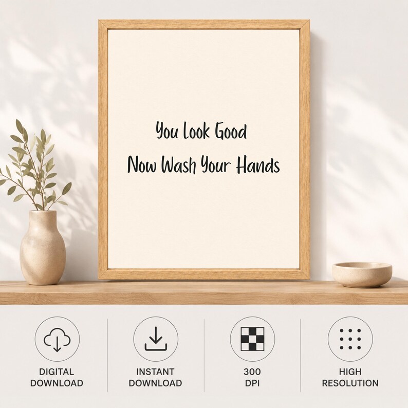 May include: A framed wall art print featuring the black text You Look Good Now Wash Your Hands on a cream background. The frame is made of light-colored wood. Below the frame are four circular icons labeled Digital Download, Instant Download, 300 DPI, and High Resolution.
