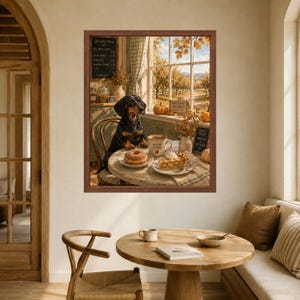 May include: A framed wall art print depicting a black and tan dachshund sitting at a round table in an orchard setting. The table features a doughnut, a slice of pie, and a mug labelled Warm Cider. The background shows an orchard through a window.