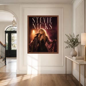 May include: A rectangular framed wall art print featuring a photograph of Stevie Nicks performing on stage with a microphone. The text STEVIE NICKS appears in large white letters at the top, with the smaller text LIVE IN THE MOMENT MAGIC IS REAL.