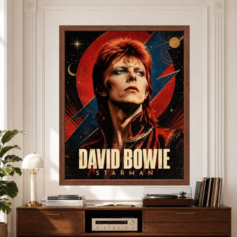 Framed David Bowie wall art featuring a vintage-inspired Starman portrait with red hair, bold red and blue lightning graphics, celestial stars, cosmic symbols and large David Bowie typography above a record player console.
