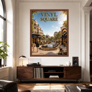 May include: A framed wall art print titled VINYL SQUARE featuring a sunny European-style plaza with a central fountain, surrounding buildings, and people walking. The artwork is displayed above a wooden media console with a turntable and vinyl records.