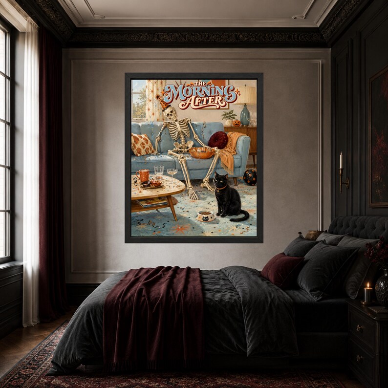 May include: A framed wall art print titled The Morning After, featuring a skeleton wearing a party hat lounging on a blue sofa with a bowl of snacks, while a black cat sits on the floor next to a food bowl in a living room setting.