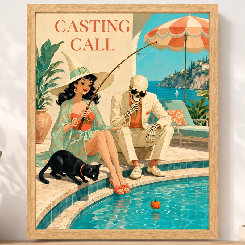 May include: A framed art print titled CASTING CALL featuring a witch in a wide-brimmed hat and a skeleton in a beige suit sitting by a swimming pool. A black cat stands on the pool edge while the skeleton holds a fishing rod with a pumpkin lure.