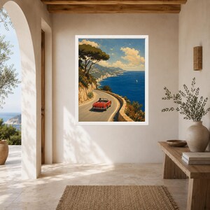 May include: A framed wall art print depicting a red convertible car driving along a winding coastal road. The scene features a deep blue sea, rocky cliffs, and a clear sky with scattered clouds, capturing a scenic Mediterranean landscape view.