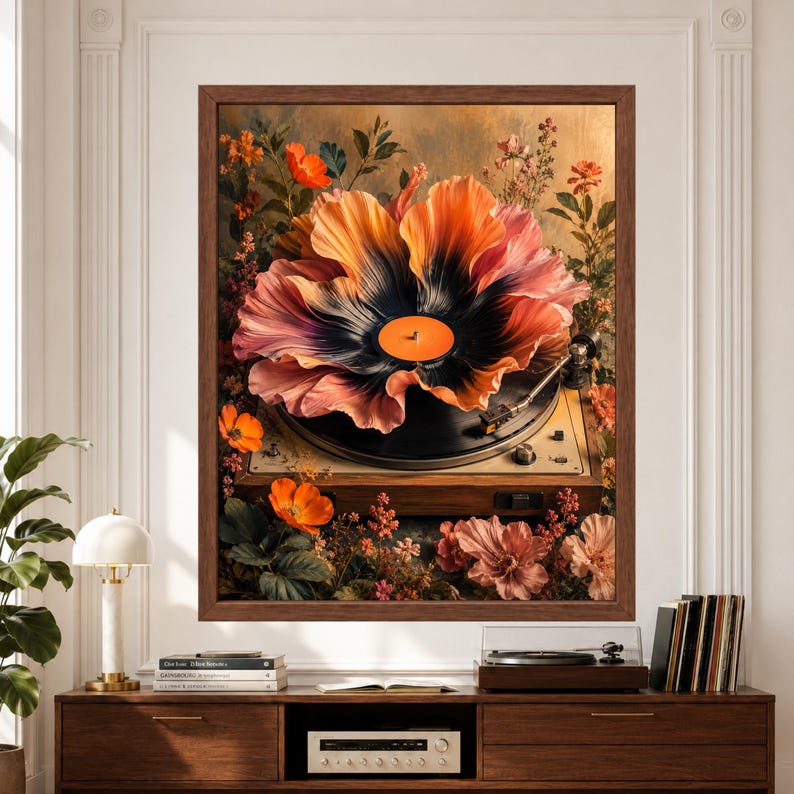 Framed vinyl record wall art featuring a black record blooming into oversized coral and peach flower petals on a vintage turntable surrounded by poppies, wildflowers and lush botanical details above a record player console.