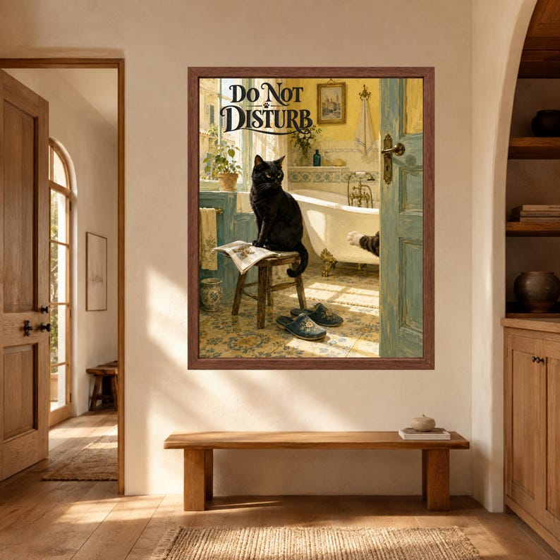 May include: A framed wall art print featuring a black cat sitting on a wooden stool in a bathroom, with the text DO NOT DISTURB printed at the top. The scene includes a white clawfoot bathtub, blue tiled walls, and a pair of blue slippers on the floor.