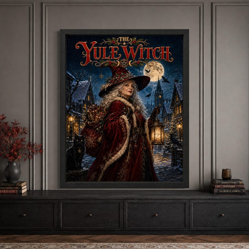 Framed Yule witch Christmas wall art featuring a silver-haired witch in a red winter cloak carrying gifts and a lantern through a snowy gothic village, accompanied by a black cat beneath a full moon with “The Yule Witch” typography.
