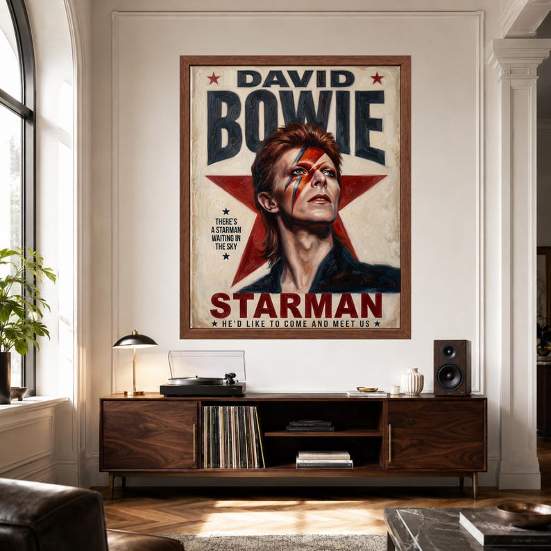May include: A framed poster featuring a portrait of David Bowie with a red lightning bolt across the face, set against a large red star. The text reads DAVID BOWIE, STARMAN, and includes the lyrics THERE'S A STARMAN WAITING IN THE SKY.